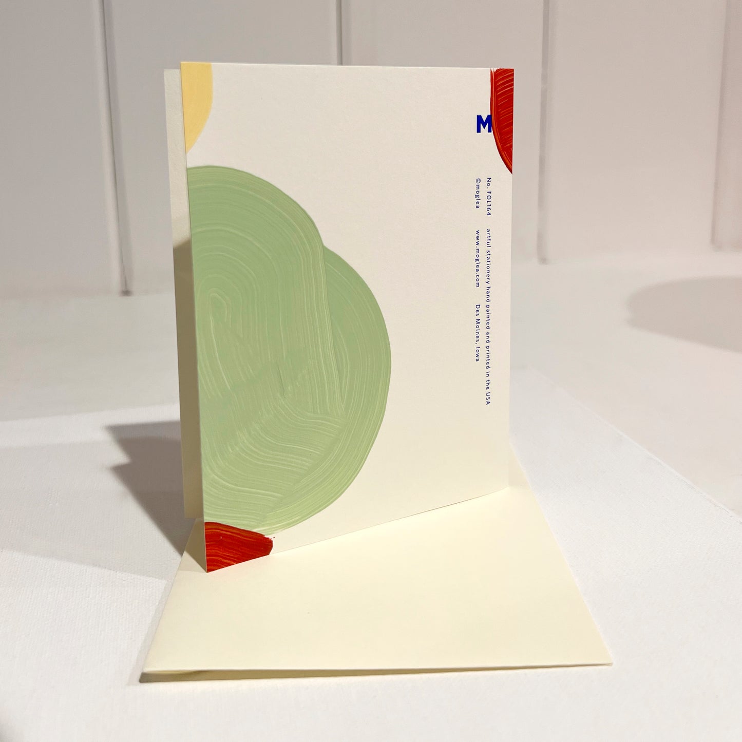 Back view "happy birthday gorgeous' greeting card with abstract semi circles design. Multi color hand painted with Moglea information foil printed