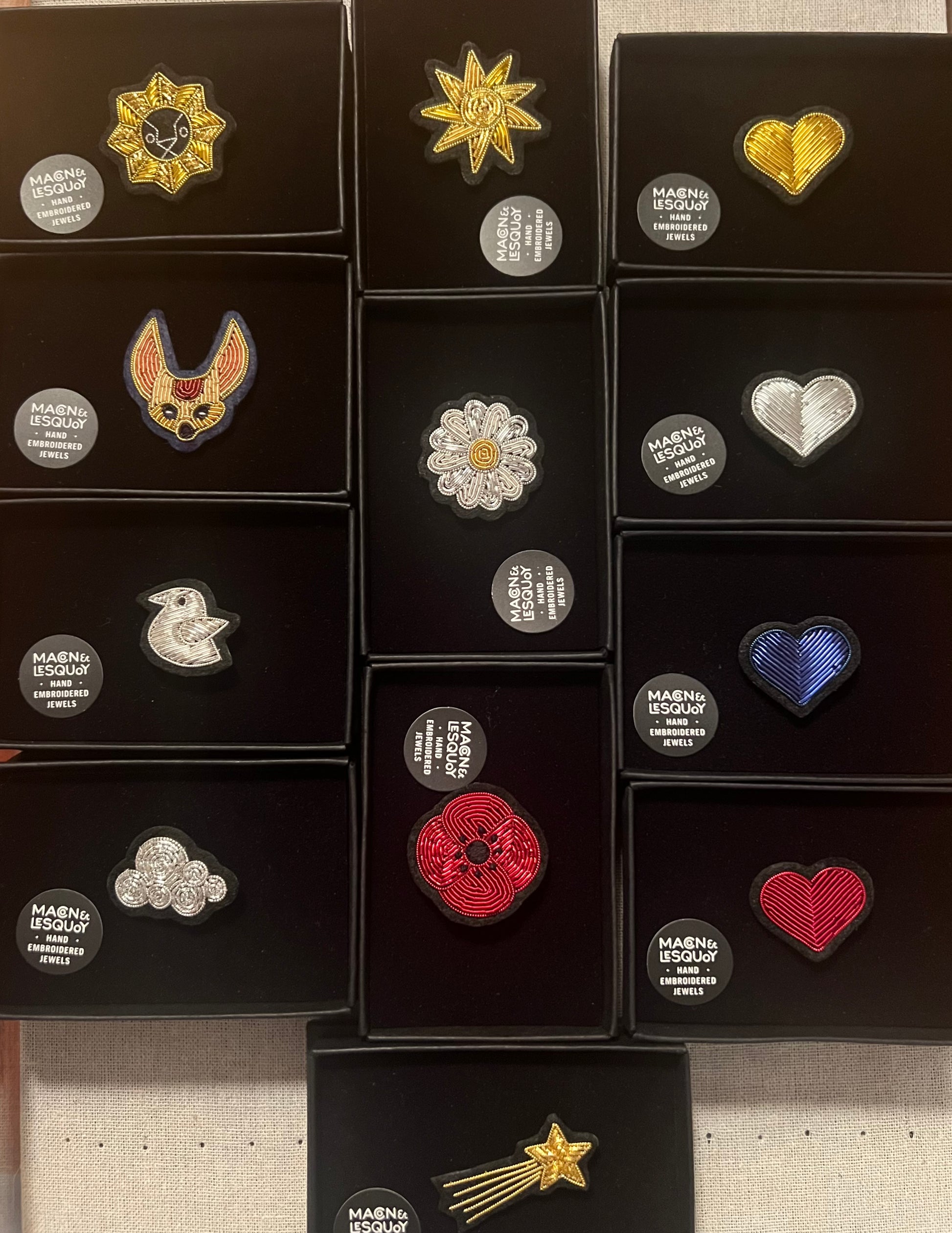 Macon and LesQuoy design brooches with velvet flock packaging and slide box tray and Logo sticker. Image for size comparison with other designs.