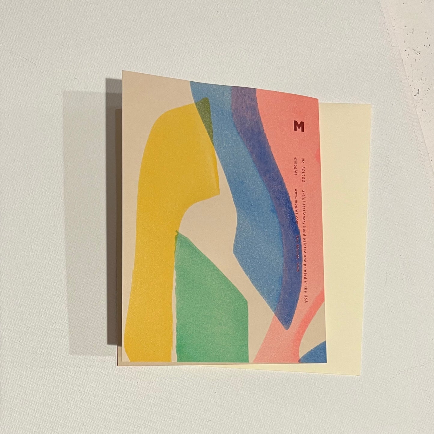Back view Hand painted multicolor folded card with foil print. Each card has a unique abstract design and color by Moglea. Paired with a off white envelope.