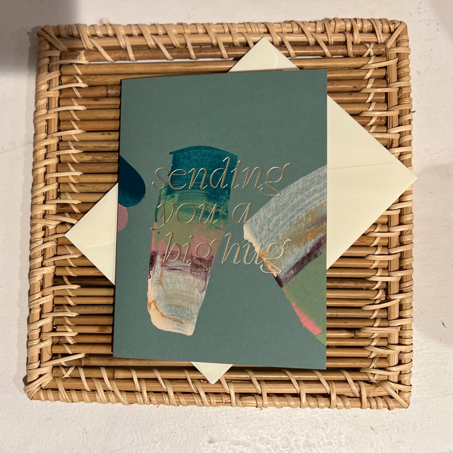 Moglea "sending you a big hug "card
Hand painted multicolor brush strokes folded card with color foil wording. Each card has a unique abstract design and color. Paired with an off white envelope.
FOLA605 big hug.
Styled on a rattan grass trivet.